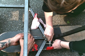 Closeup of Broken Vehicle Being Fixed With Hose Clamps